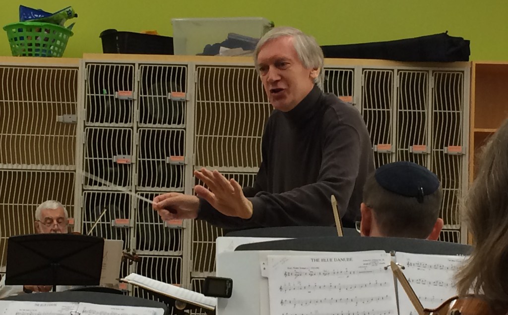 Conductor Matthew Poon giving directions to the orchestra during rehearsal