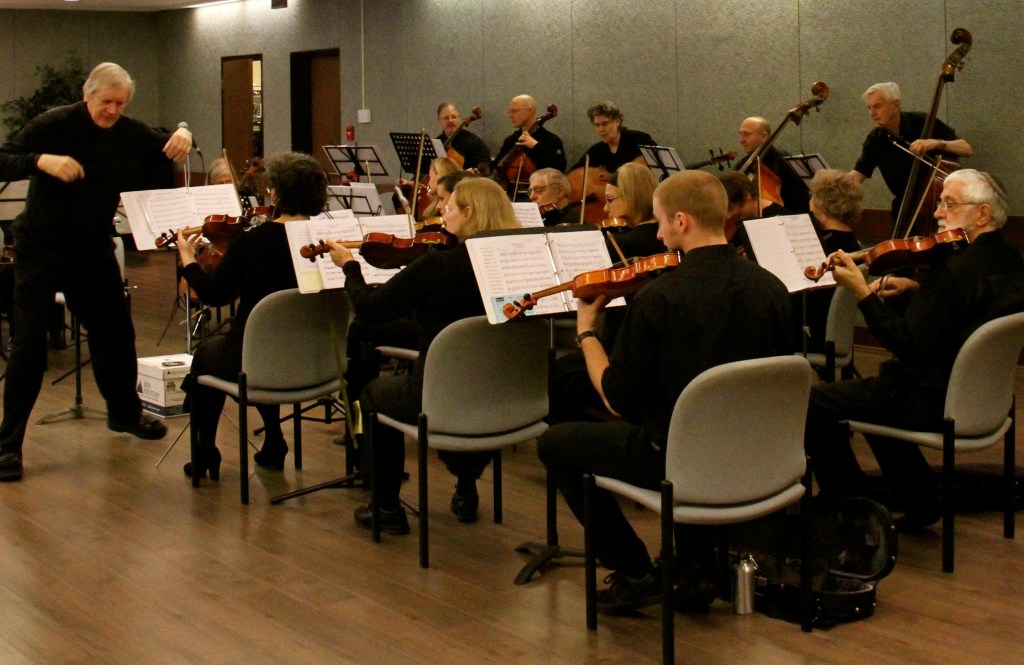 Strings Attached Orchestra performing with its conductor at The Terraces of Baycrest community concert