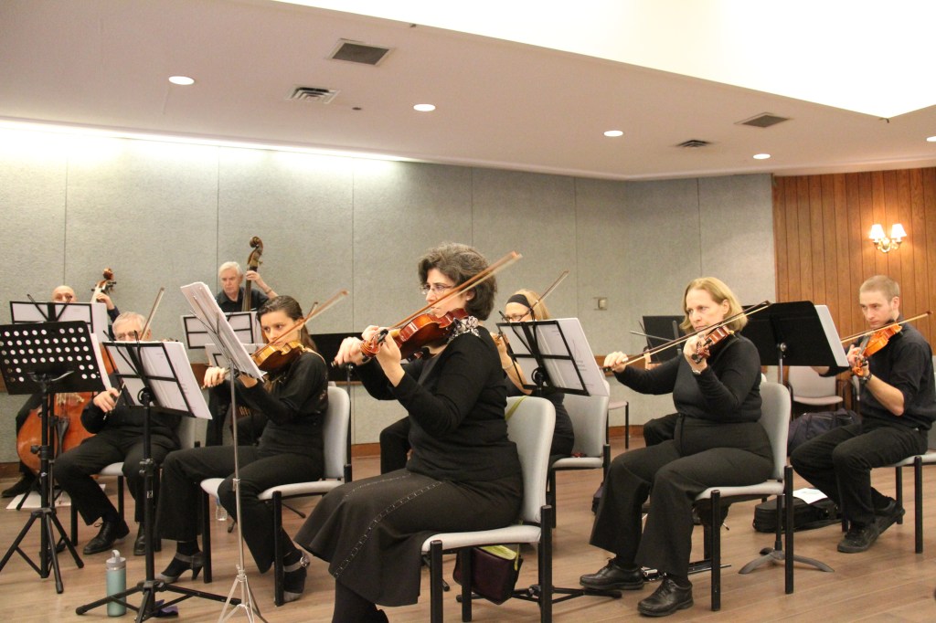 Violinists and violists performing at the community concert at The Terraces of Baycrest
