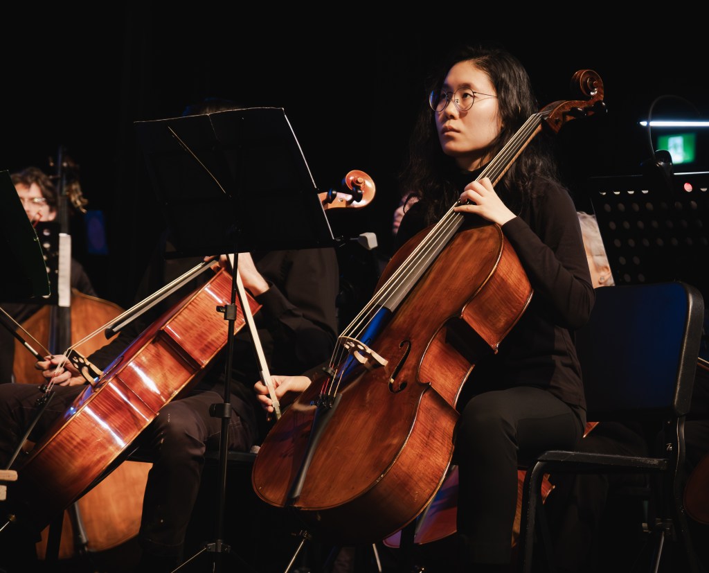 Cellists playing on stage
