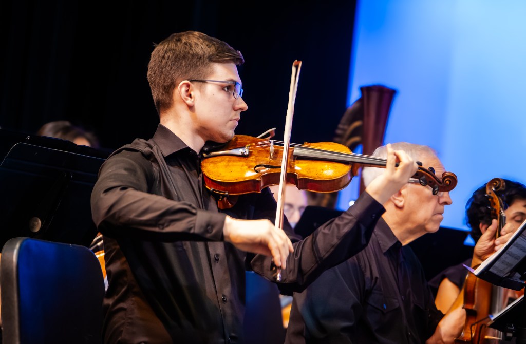 A violinist playing on stage