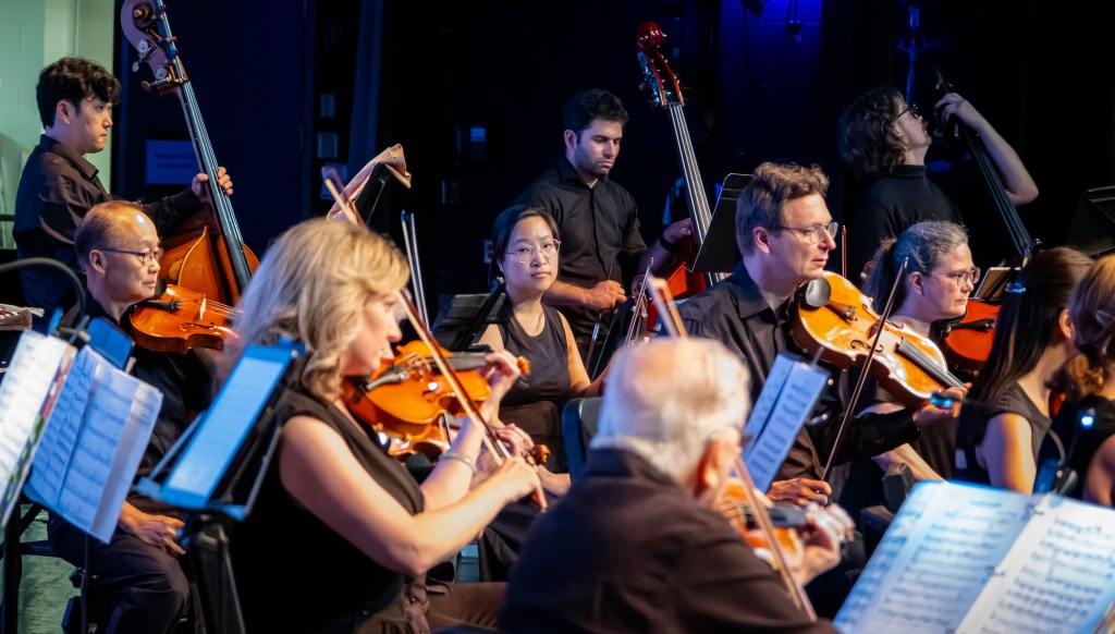 Violinists playing from tablets and music stands