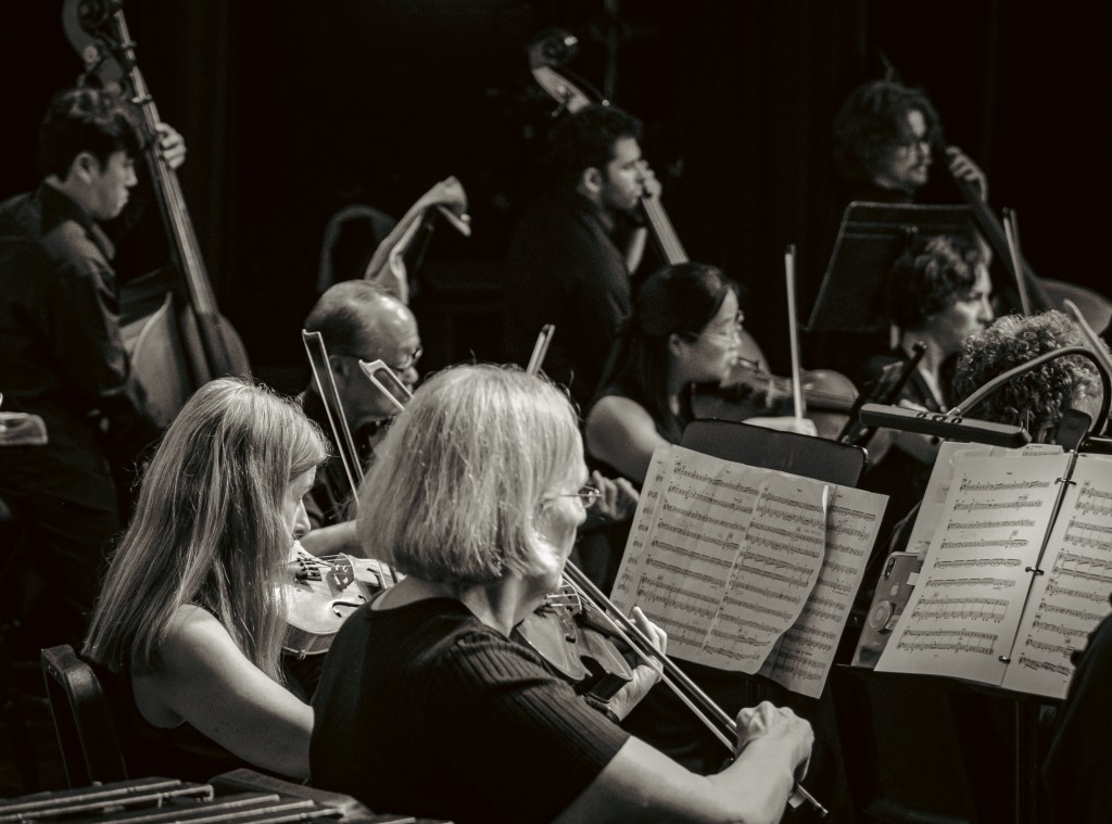Black-and-white photo of viola players reading from their stands