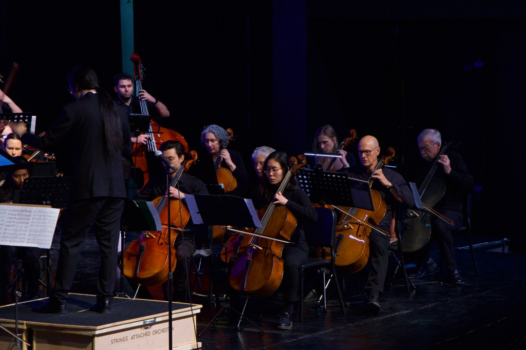 Jonathan Wong conducting, with the cellos and basses beside him