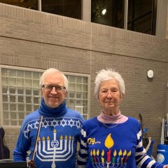 Photo, 2025 Ontario Shores community concert: two orchestra members in Hanukkah sweaters with a violin