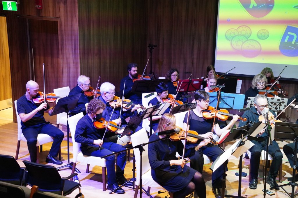 String players performing under coloured stage lights