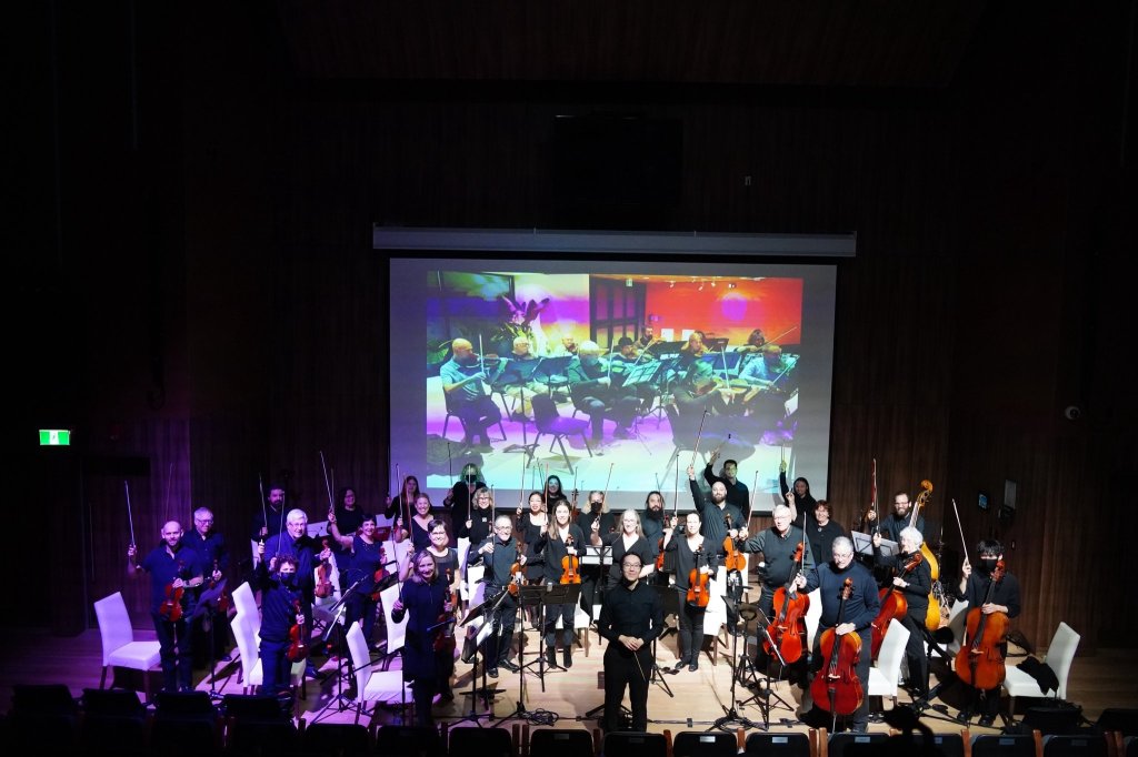 The orchestra on stage seen from the audience