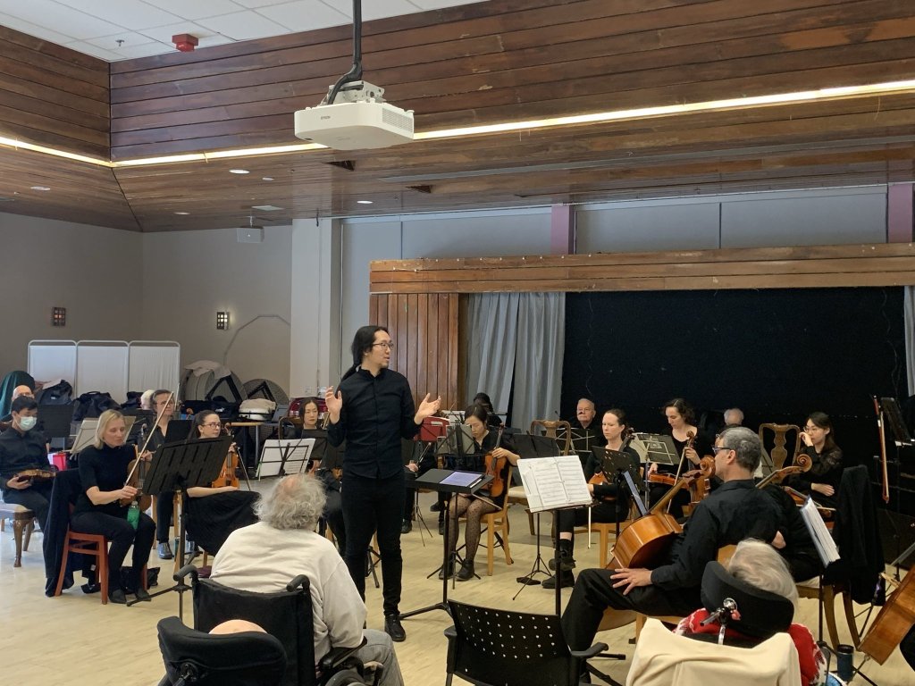 Residents listening as the orchestra performs at Castleview Wychwood Towers