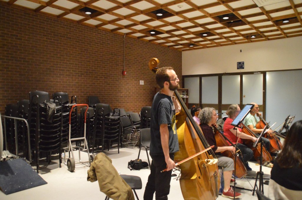 A bassist rehearsing with the orchestra