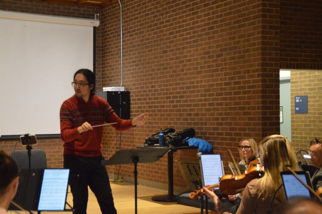 The conductor leading rehearsal