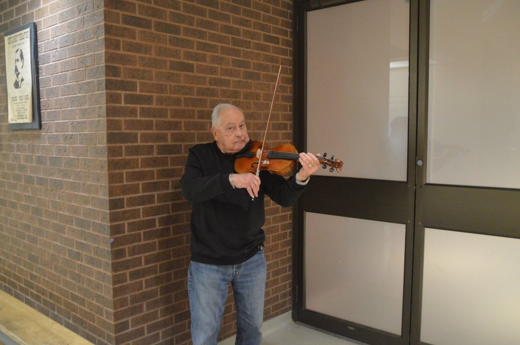 A violinist from the orchestra warming up before rehearsal