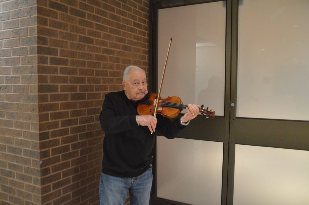 Portrait of a violinist from the orchestra with his violin