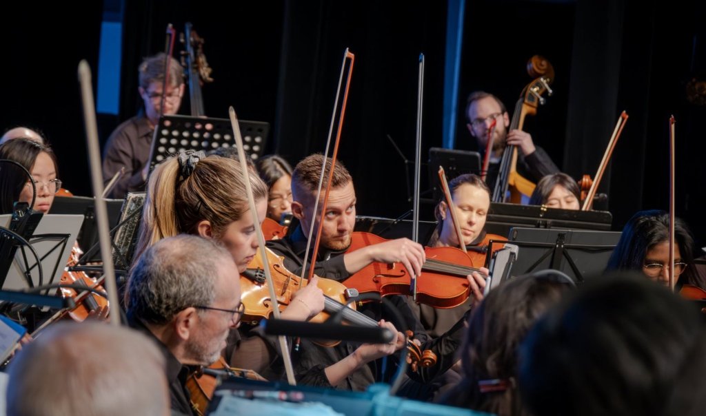 Violinists playing at the 2024 Holiday Concert