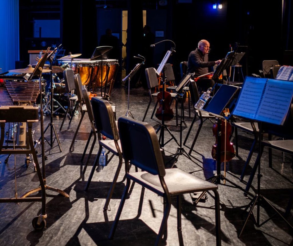 Empty chairs and music stands on stage before the concert