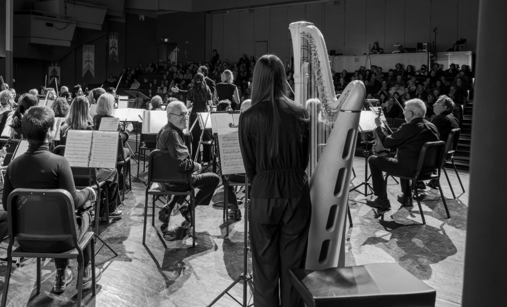 Black-and-white photo of the harp on stage