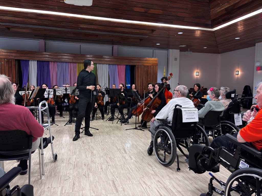 The orchestra performing for residents at Castleview Wychwood Towers