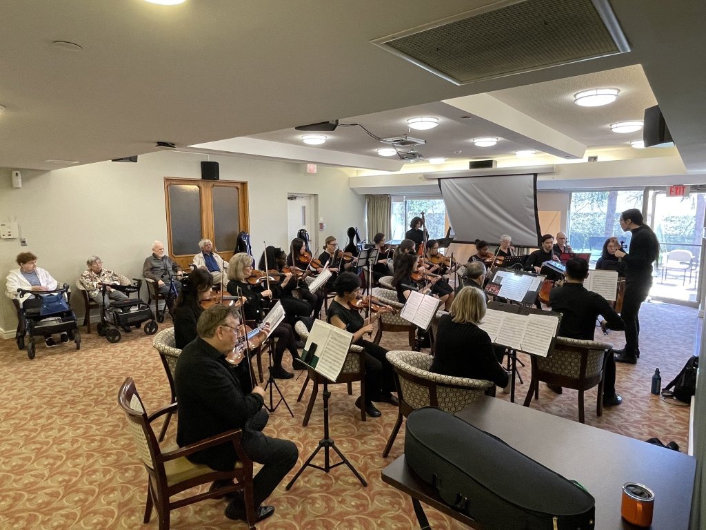 Residents listening to the orchestra at Chartwell Gibson