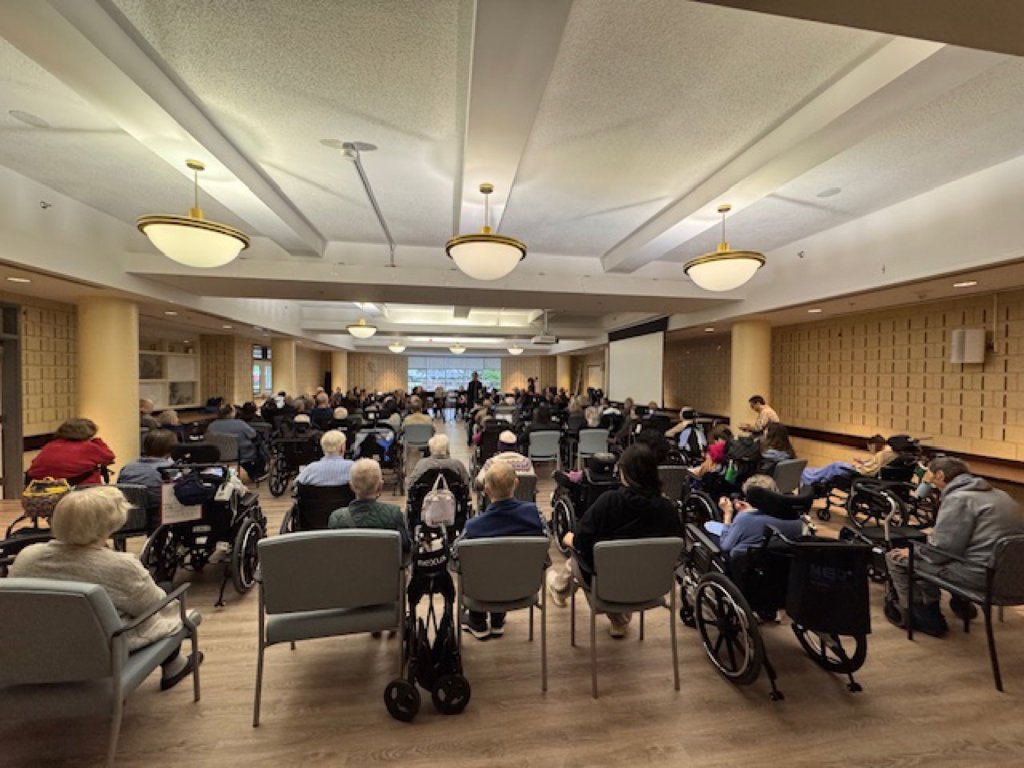 Residents listening to the orchestra at Cummer Lodge