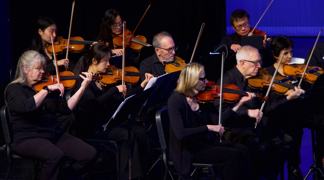 Violinists playing together on stage