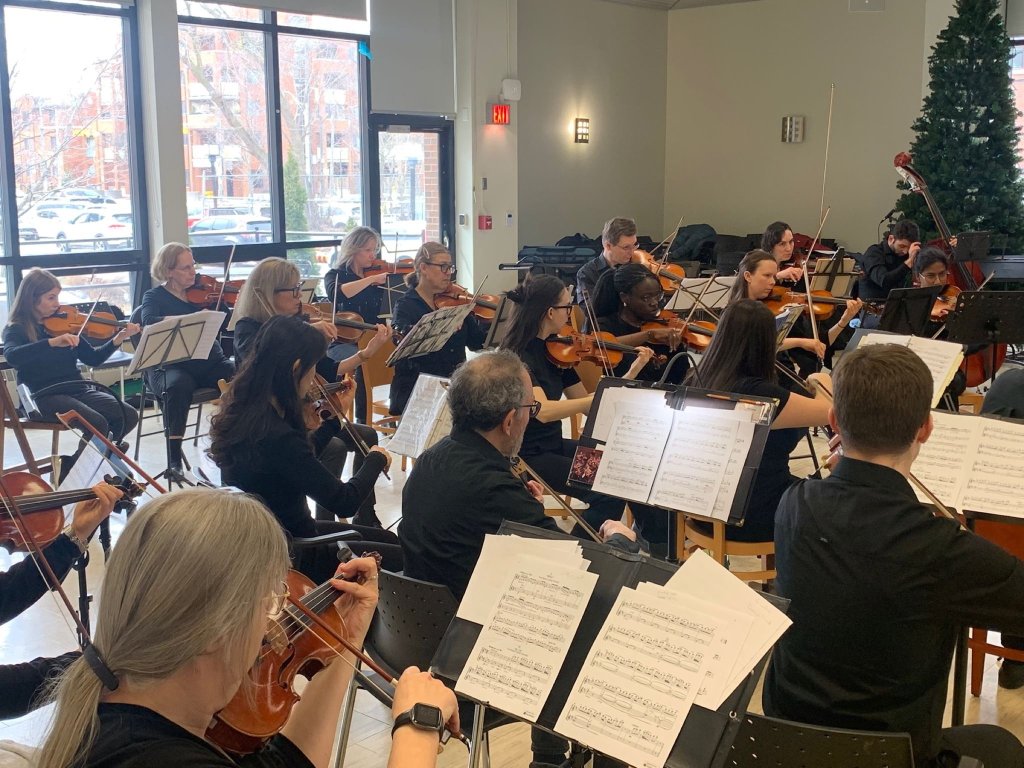 The orchestra performing at Castleview Wychwood Towers