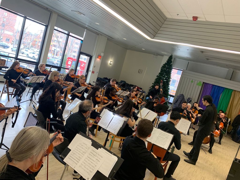 Violinists performing at Castleview Wychwood Towers