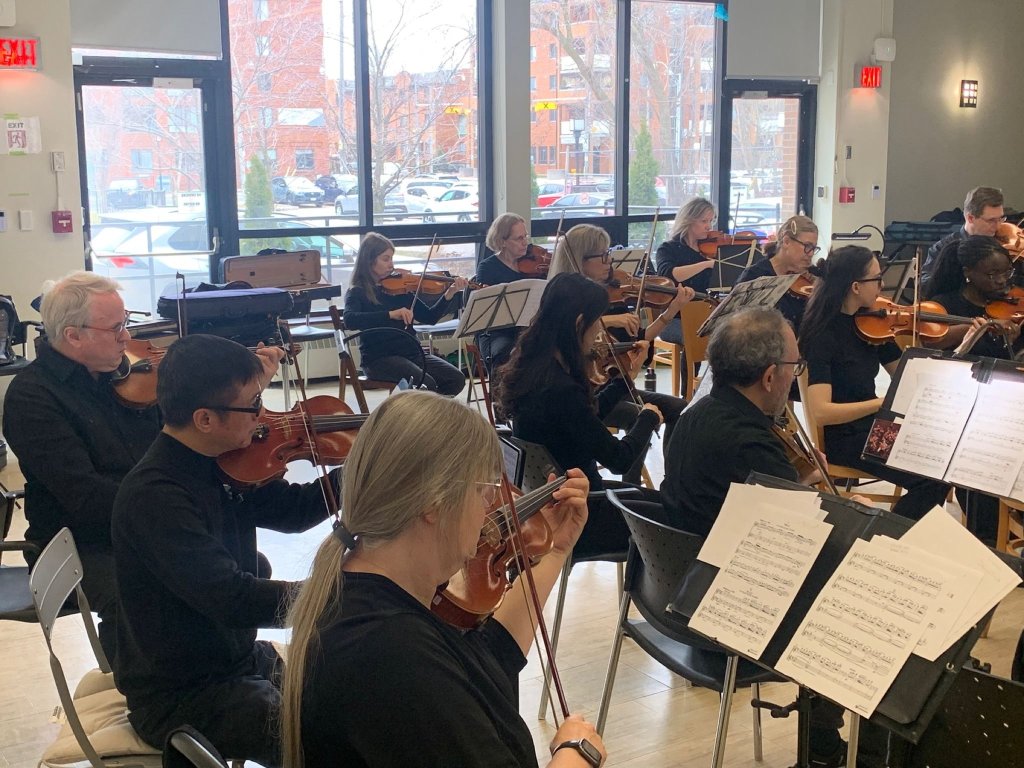 Violinists performing at Castleview Wychwood Towers