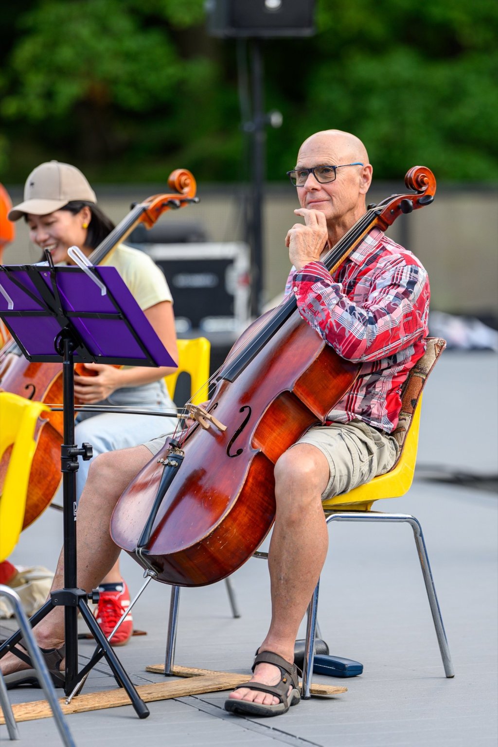 A cellist playing at the Earl Bales Park amphitheatre