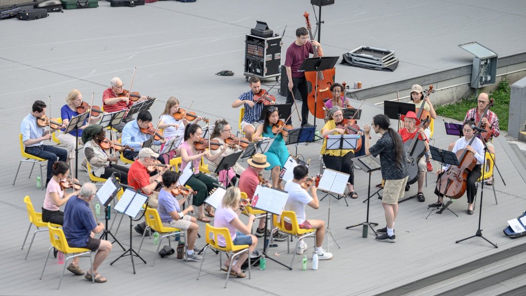 The orchestra and young players on stage at Earl Bales Park