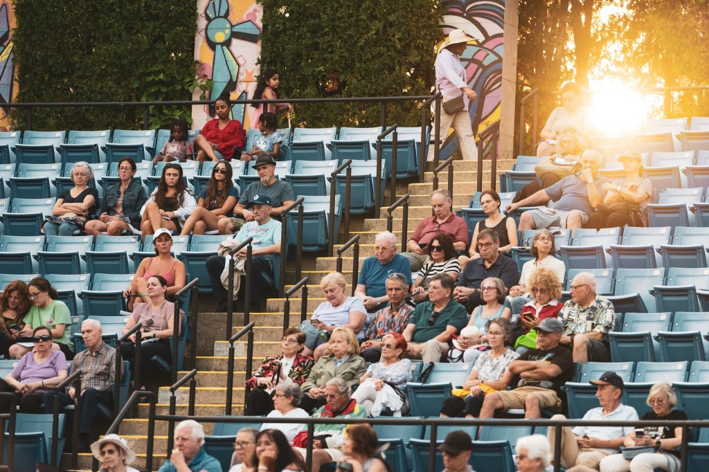 The audience in the amphitheatre in the evening sun
