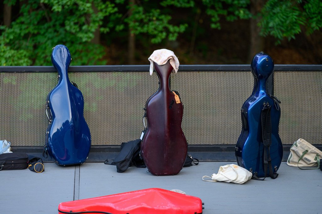 Cello cases waiting at the side of the stage